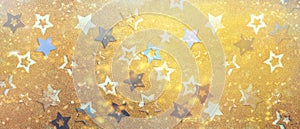Christmas celebration. Abstract background for new year party. Patter of gold stars with lights, bokeh. Golden glitter stars on