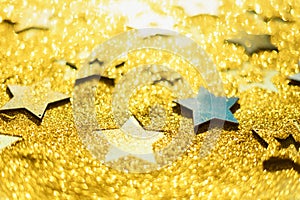 Christmas celebration. Abstract background for new year party. Patter of gold stars with lights, bokeh. Golden glitter stars on