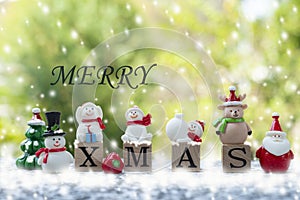 christmas celebration concept, santa doll , wooden cubes X MAS and MERRY letters with snow decoration