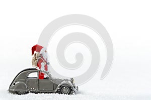 Christmas celebration, Santa Claus standing in a french 2cv vintage car with gift sack, Isolated on White Background