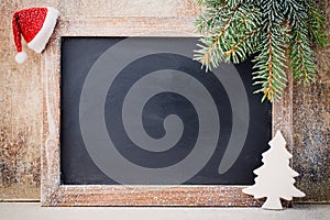Christmas chalkboard and decoration over wooden background.