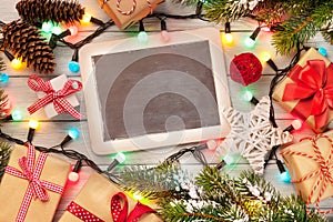 Christmas chalkboard, gifts, lights and fir tree
