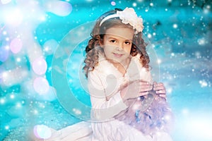Christmas child girl on winter tree background, snow, snowflakes