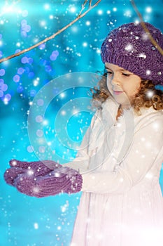 Christmas child girl on winter tree background, snow, snowflakes