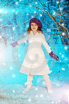 Christmas child girl on winter tree background, snow, snowflakes