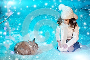 Christmas child girl on winter tree background, snow, snowflakes