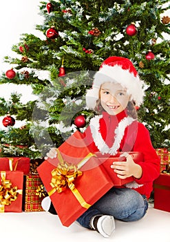 Christmas helper child sitting under fir tree, hol