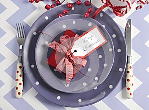 Christmas children family party table place settings in purple, red and white theme