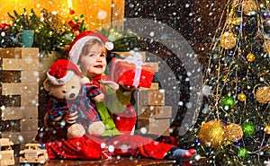 Christmas childs in snow. Dreamy baby toddler on christmas eve. Believe in christmas miracle. Wish to meet santa claus