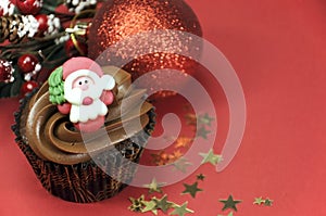 Christmas chocolate cupcake with Santa face and copy space