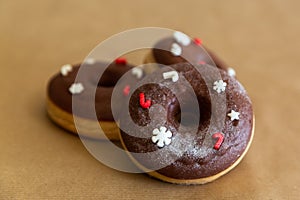 Christmas chocolate donuts decorated red and white sprinkles, selective focus