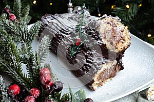 Christmas chocolate log, Buche de Noel, festive holiday cake and decorations photo
