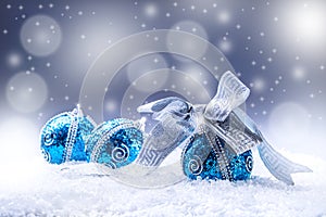 Christmas. Christmas blue balls and silver ribbon snow and space abstract background.