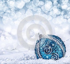 Christmas. Christmas blue balls and silver ribbon snow and space abstract background.