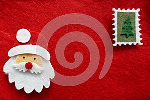 Christmas, Christmas motives, Christmas card. Head of a Santa Claus and a Christmas tree on red felt. Background, Texture, Close-u