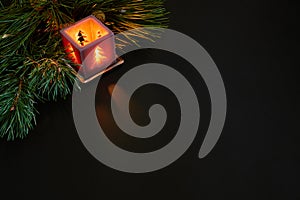 Christmas, christmas tree, candle, cones and cinnamon sticks on black background