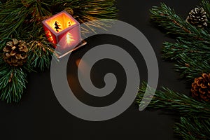 Christmas, christmas tree, candle, cones and cinnamon sticks on black background