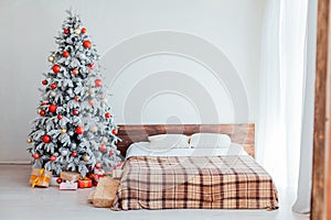 Christmas Christmas tree with presents in a white room in winter