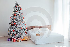 Christmas Christmas tree with presents in a white room in winter