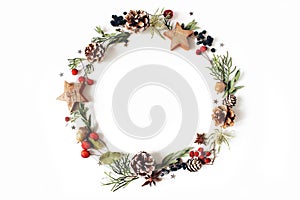 Christmas circle floral composition. Wreath of cypress, eucalyptus branches, pine cones, rowan berries, anise, confetti