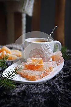 Christmas citrus dessert, orange jelly sweets and cup of coffee, New Year\'s decoration