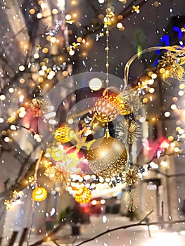 Christmas city market decoration on evening street lantern light and gold confetti,guirlande and blurred light in Tallinn old town