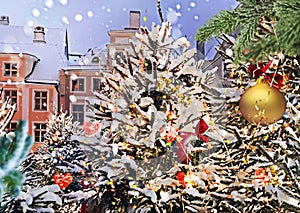 Christmas city winter Tallinn Christmas tree gold ball and confetti red bow decoration on medieval snowy street holiday in Old tow