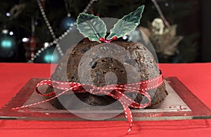 Christmas classic plum pudding with holly on red tablecloth