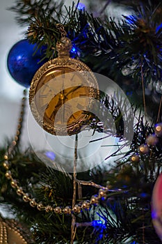 Christmas clock on the Christmas tree with beads and Christmas decorations