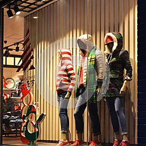 Christmas clothing window,Winter fashion boutique display window with mannequins