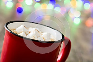 Christmas cocoa with marshmallow and Christmas lights background on wod