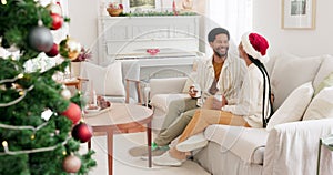 Christmas, coffee and holiday with a black couple on a sofa in their living room together for celebration. Love, magic