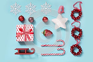 Christmas collection with candy canes, heart, balls, red sleid for mock up template design on blue. Flat lay. Top view.