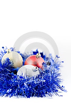 Christmas colored balls in blue tinsel