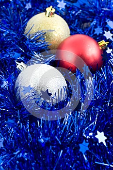 Christmas colored balls in blue tinsel