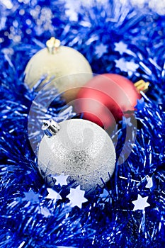 Christmas colored balls in blue tinsel