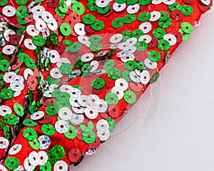 Christmas colours, red, green and silver shiny sequins on large red bow