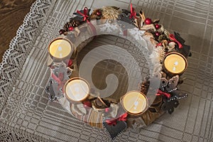 Christmas is coming with Advent. Beautiful closeup of Advent wreath made from natural materials and ceramic decors