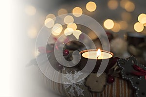 Christmas is coming- first Advent. Closeup of burning candle of Advent wreath made from natural materials and golden