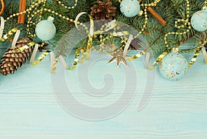 Christmas composition background from Christmas tree branches and gold blue decorations