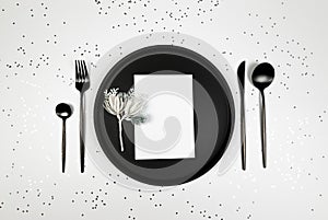 Christmas composition, black plate and cutlery, white card, fir tree branch, silver stars confetti on white background.