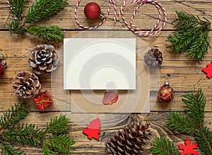 Christmas Composition with a blank card and envelope over wooden table flat lay