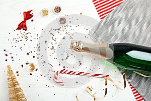 Christmas composition with bottle of champagne and decor on wooden background