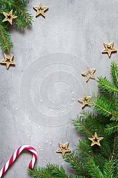 Christmas composition. Christmas candy cane, golden star and fir tree branches. Top view, flat lay