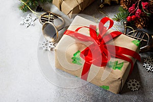 Christmas composition. Christmas gift box, branch of a Christmas tree and decorations on a gray stone or slate background. Ð¡opy
