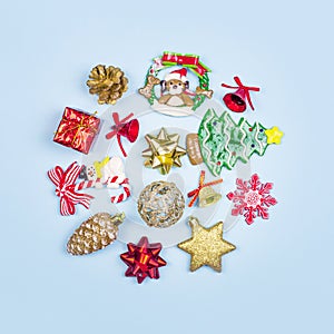 Christmas composition. Christmas gifts, decor, toys on a blue background in the form of a circle. Flat lay, top view