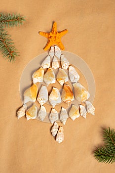 Christmas composition. Christmas in the summer, Christmas tree made of seashells. New year concept. Flat lay, top view