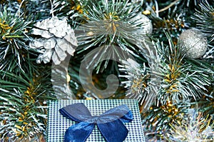 Christmas composition with Christmas tree branches in blue and silver balls and blue gift box