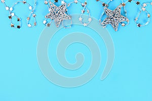 Christmas composition from Christmas tree toys. White decor on a blue background. Copy space, flat lay, top view.