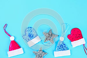 Christmas composition from Christmas tree toys. White decor on a blue background. Copy space, flat lay, top view.